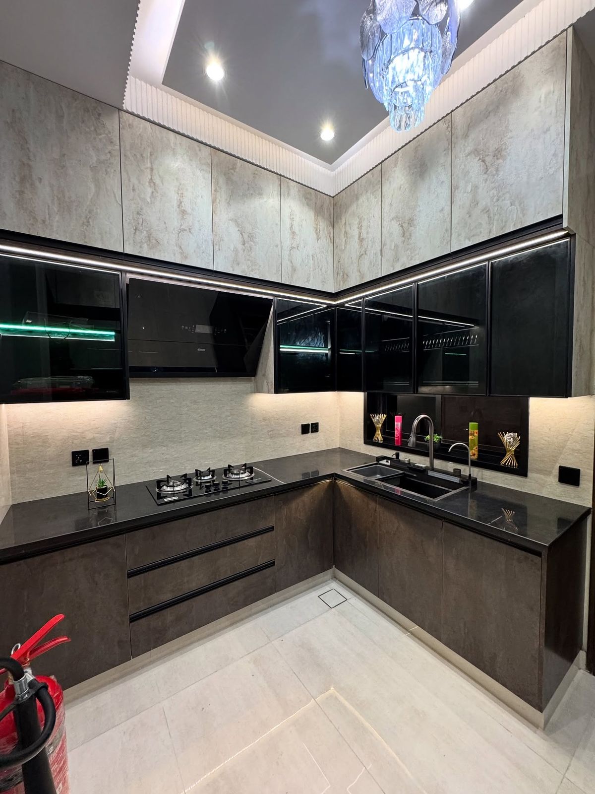 Monolithic luxury modular kitchen with textured stone and dark glass cabinetry