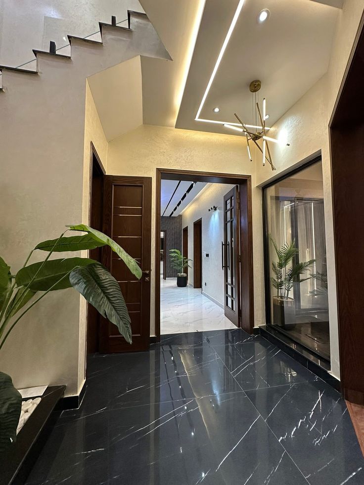 Sculptural double-height entrance foyer with floating architectural staircase